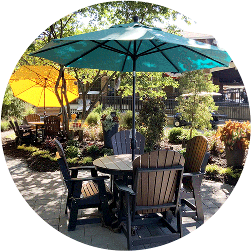 A set of black and brown Amish furniture with a light blue umbrella.